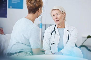 Doctor having a conversation with a patient about health concerns during consultation.