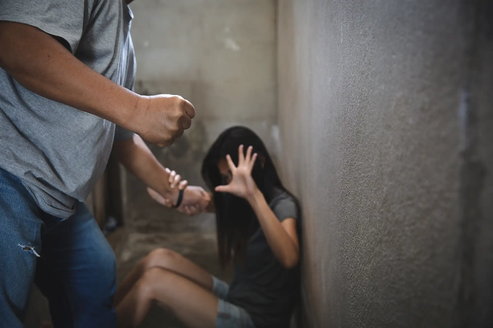 Woman facing threat of assault, highlighting trauma from domestic violence.