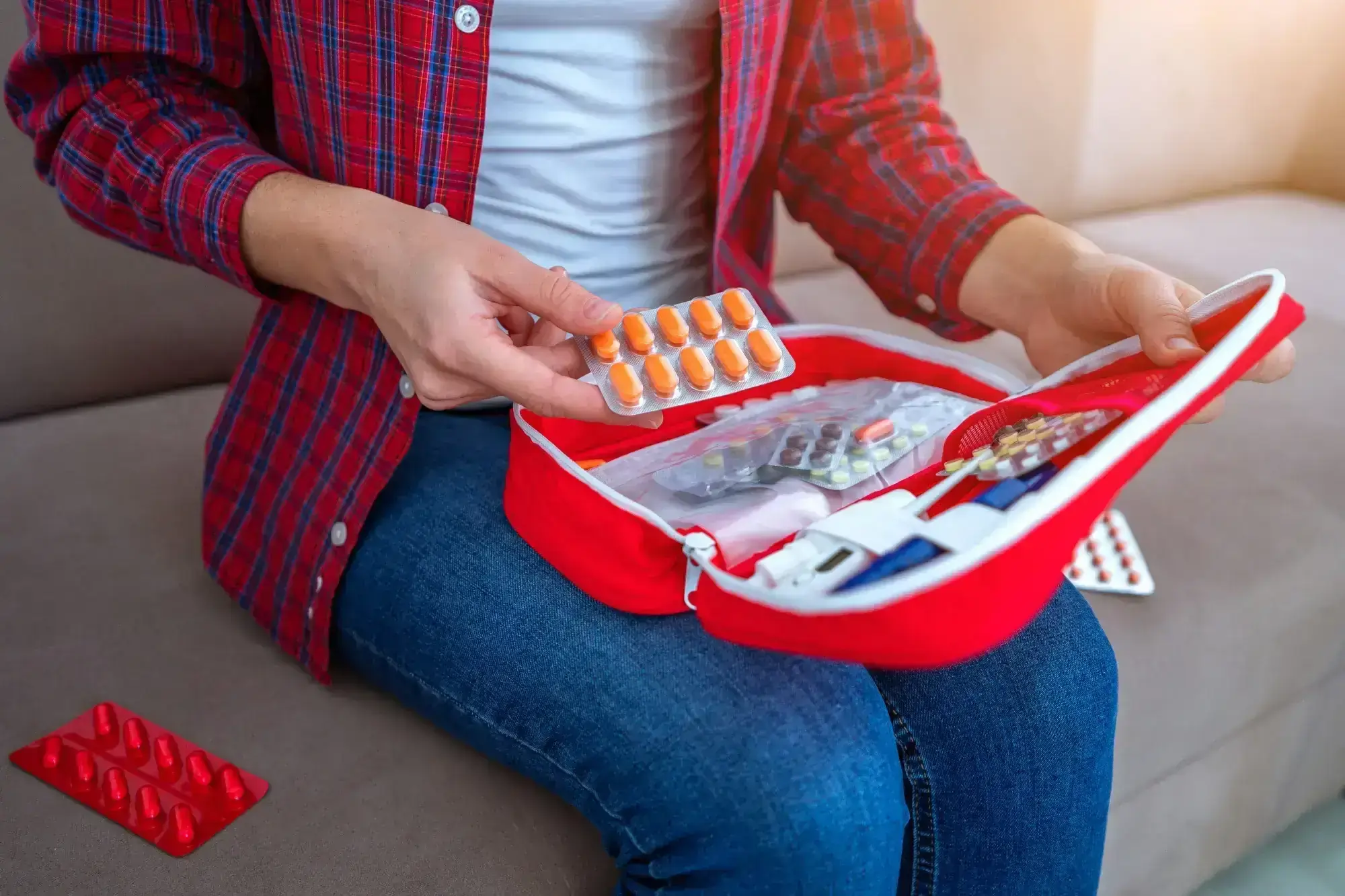 Man holding a first aid box filled with medications, symbolizing support for Suboxone treatment.
