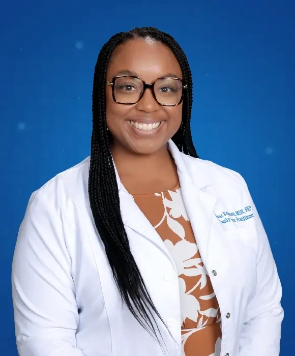 Alexus Robinson, MSN, FNP-C, smiling in clinical setting at Rapid Care Family Medicine and Urgent Care.