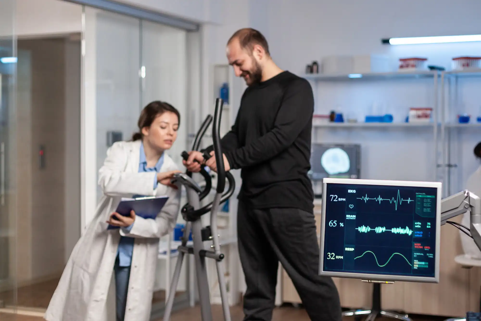 Doctor assisting patient in using a chronic condition monitoring device during a physical examination.