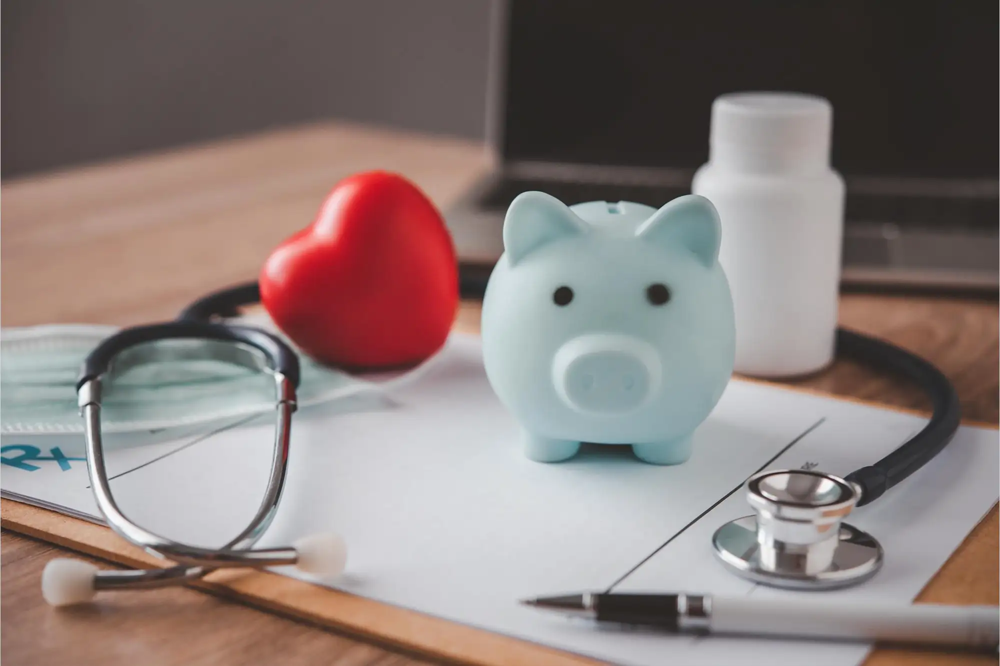 Medical tools with piggy bank showing affordable healthcare concept.