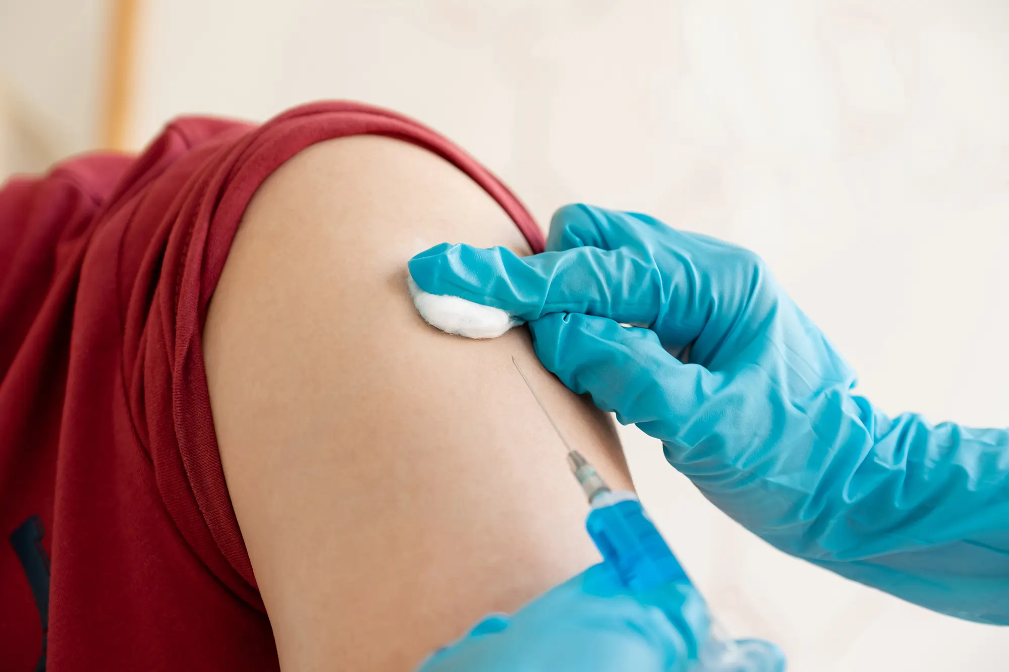 Doctor administering a standard flu shot to a woman during a routine vaccination.