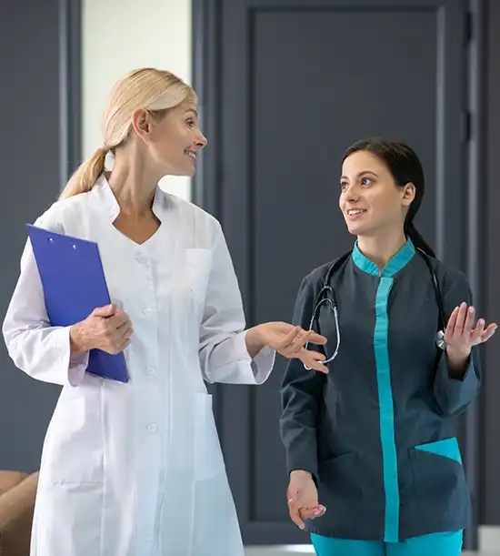 Two doctors having a discussion about a patient’s health condition in a clinical office.