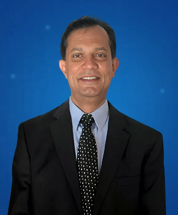 Dr. Suriya Jayawardena (Dr. Jay), founder of Rapid Care, standing confidently in clinical setting.