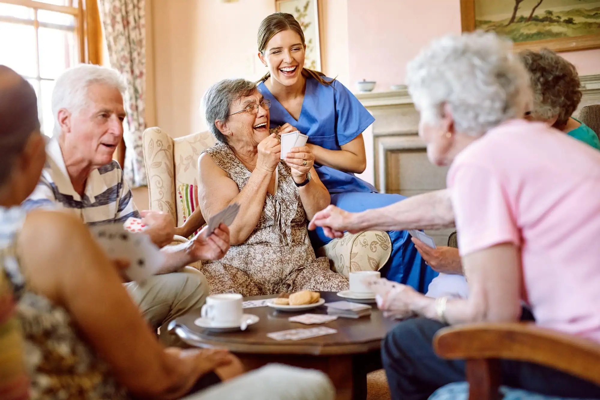 Family gathered at coffee table showing emotional and whole-care support.