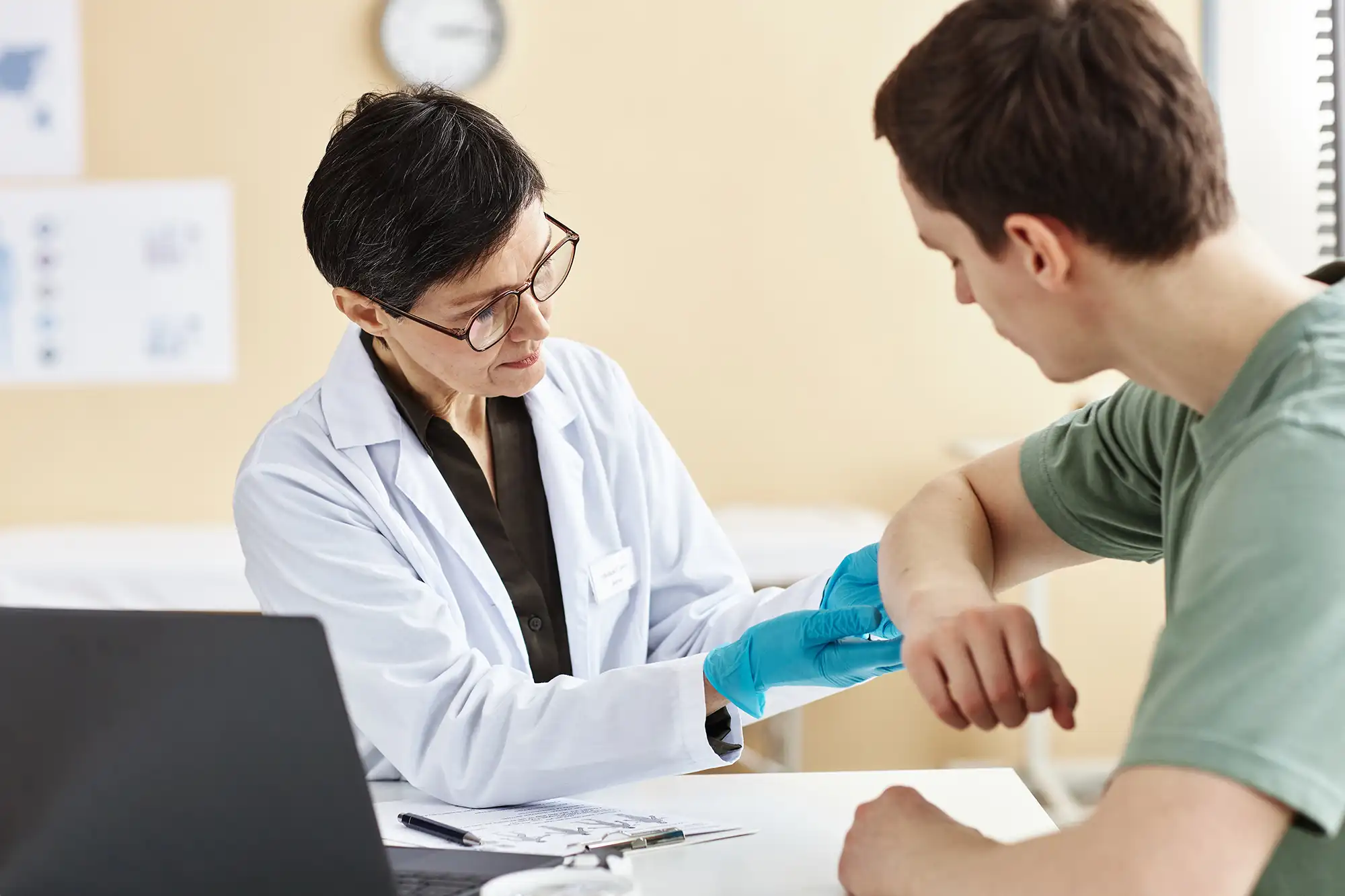 Healthcare provider assessing a female patient during a work-related physical exam.