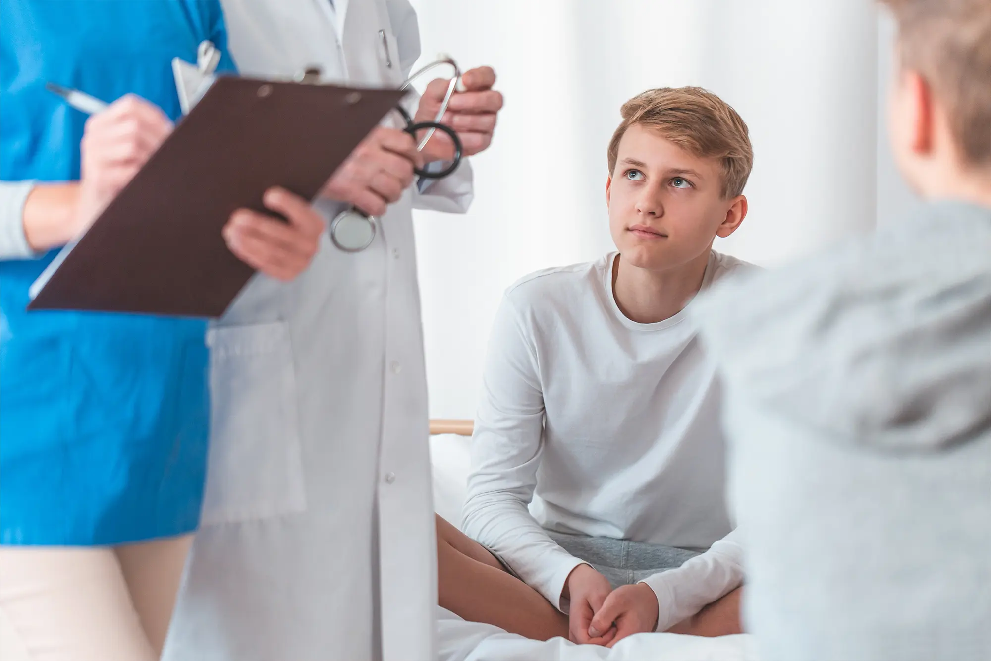 Group of doctors consulting with children to identify early health concerns.
