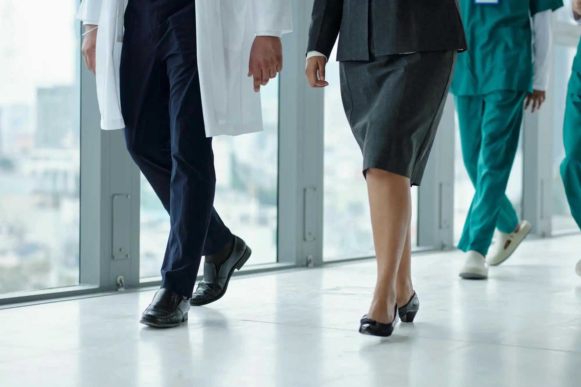 Group of doctors on hospital rounds, symbolizing prompt attention through walk-in and be-seen medical care.