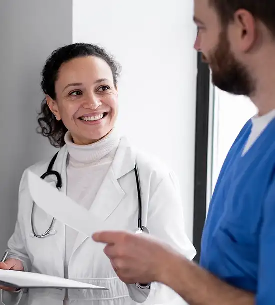 Group of professional physicians standing together holding medical reports.