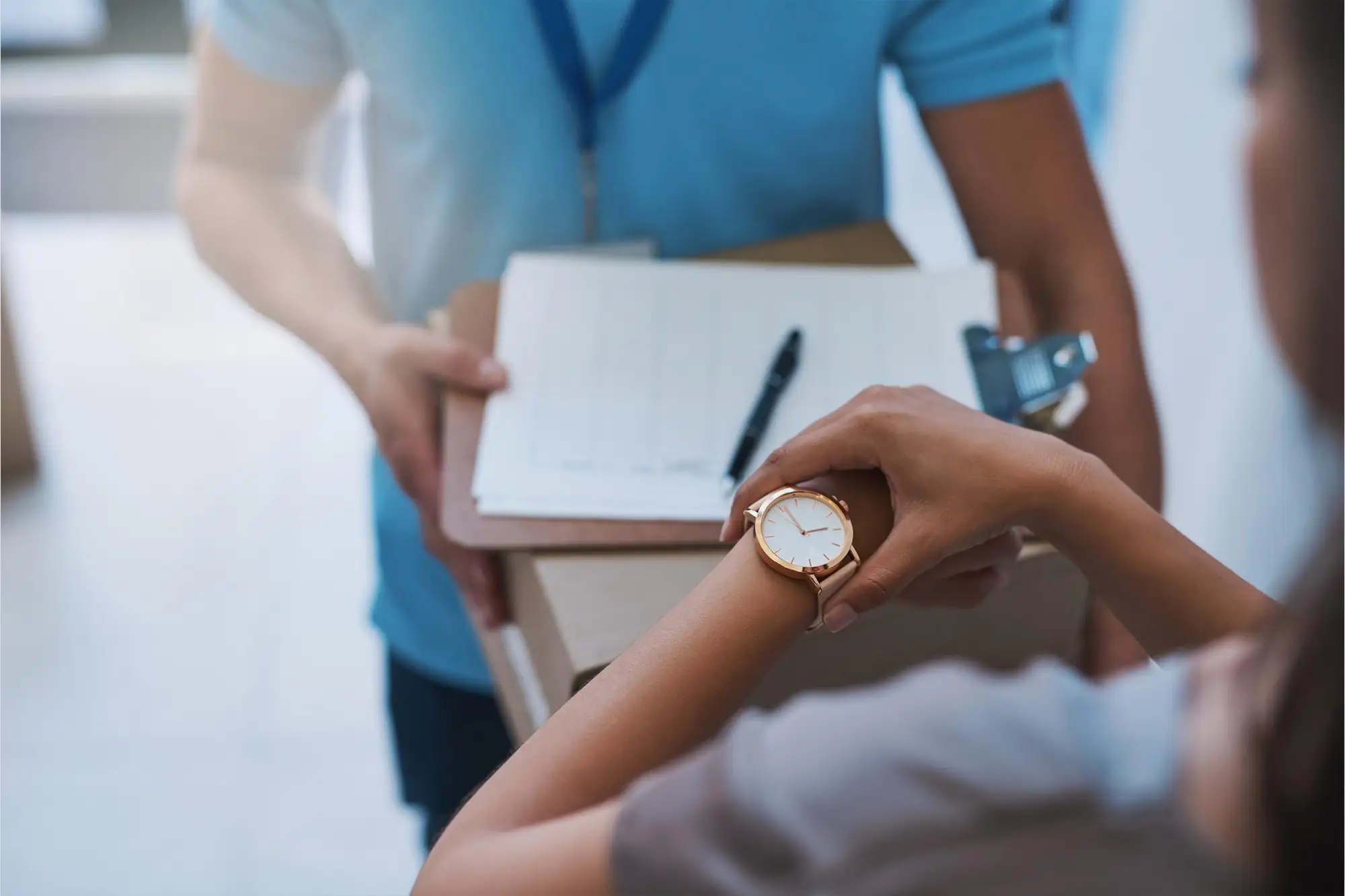 Woman checking her watch, representing minimal or no wait times for medical appointments.