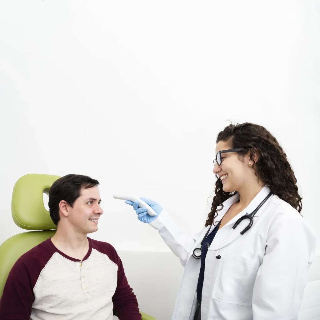 Doctor checking a patient's temperature during an ear infection evaluation at Rapid Care