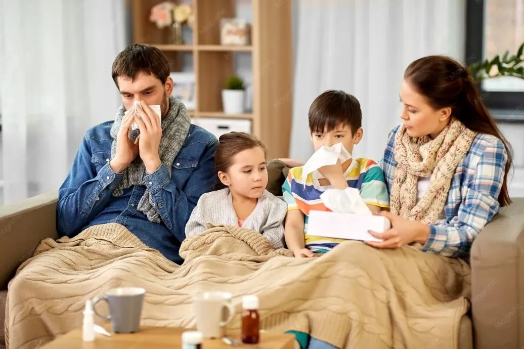 Family experiencing flu symptoms together at home