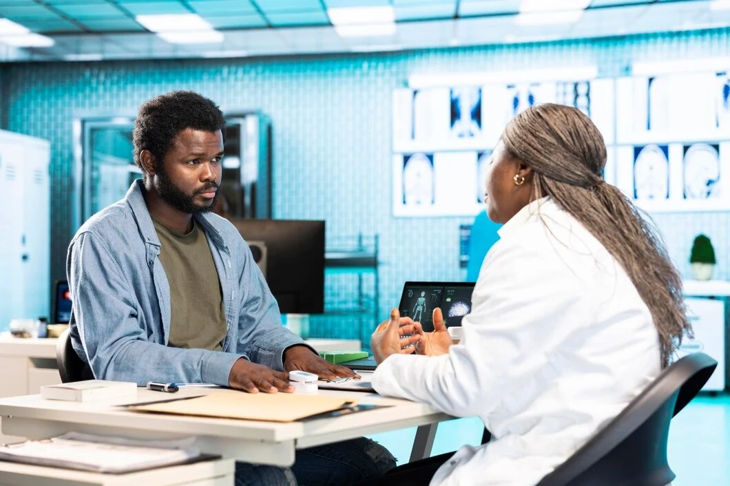 Female doctor discussing health screening results with a male patient at Rapid Care’s clinic in Sanford, NC
